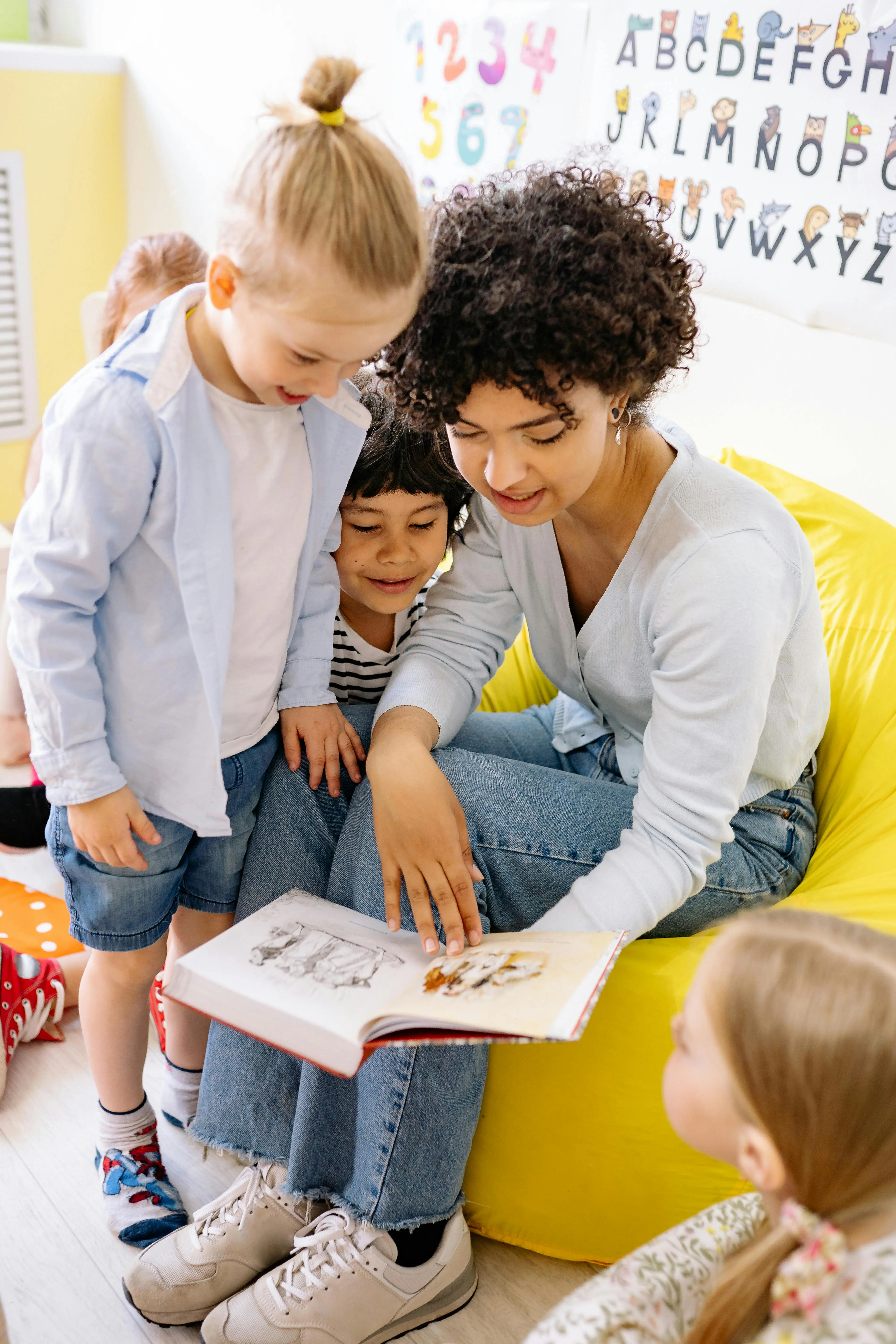 Teacher reading a picture book with young children